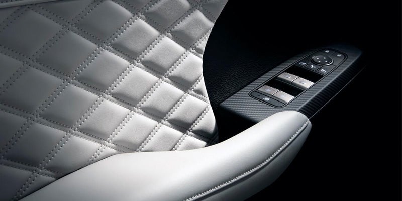 Image of the 2024 Mitsubishi Outlander featuring a close-up of the quilted interior on the door